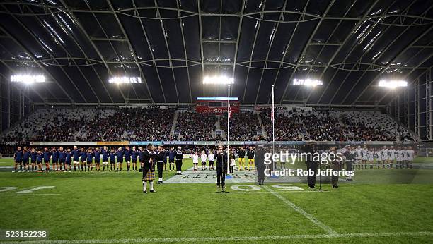 The Highlanders and Sharks stand in silence for a moment in remembrance of ANZAC Day during the round nine Super Rugby match between the Highlanders...