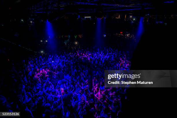 The crowd at a dance party inside First Avenue nightclub is drenched in purple light on April 22, 2016 in Minneapolis, Minnesota to celebrate the...