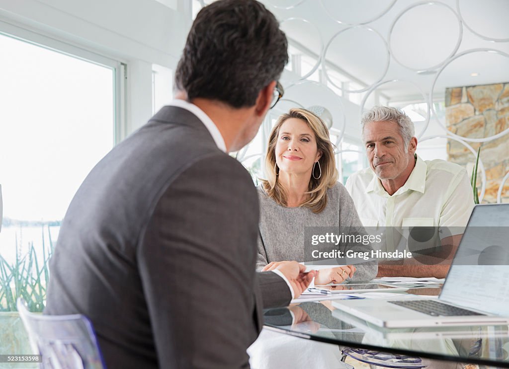 Couple talking to financial advisor