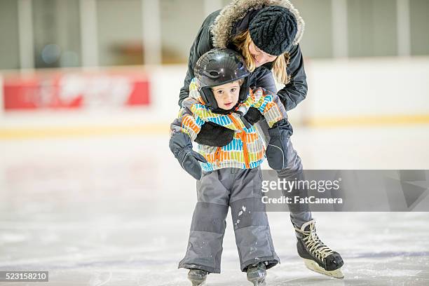 little boy learning to skate - hockey skate stock pictures, royalty-free photos & images