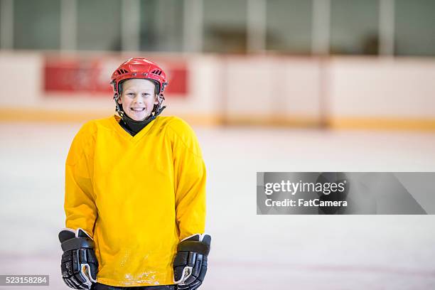 boy at hockey practice - hockey jersey stock pictures, royalty-free photos & images