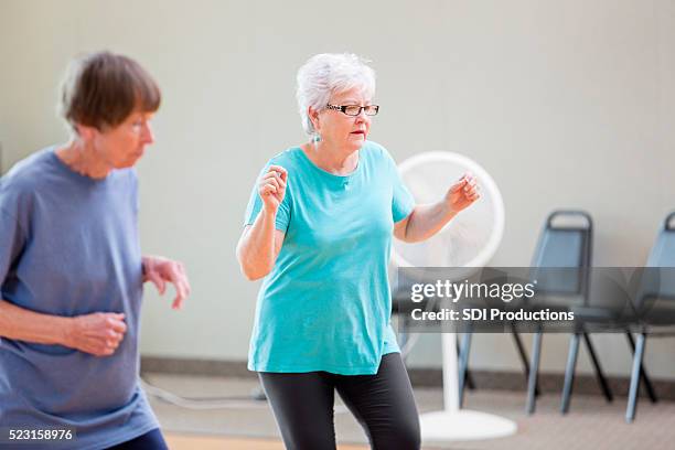 senior women enjoying line dancing - line dancing stock pictures, royalty-free photos & images