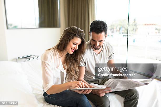 business couple reading newspaper on bedroom - read and newspaper and bed stock pictures, royalty-free photos & images