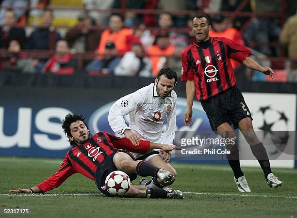 Ryan Giggs of Manchester gets tackled by Gennaro Gattuso of AC Milan during the Champions League last 16, second leg match between Milan and...