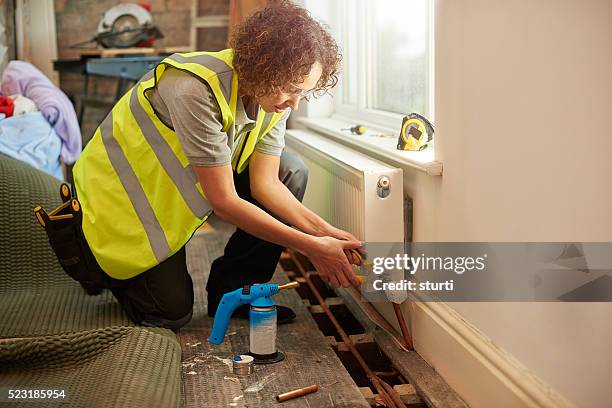 female heating contractor - safety glasses at home stock pictures, royalty-free photos & images