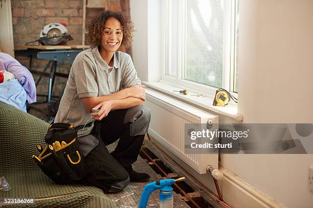 female plumber on site - flooring contractor stock pictures, royalty-free photos & images