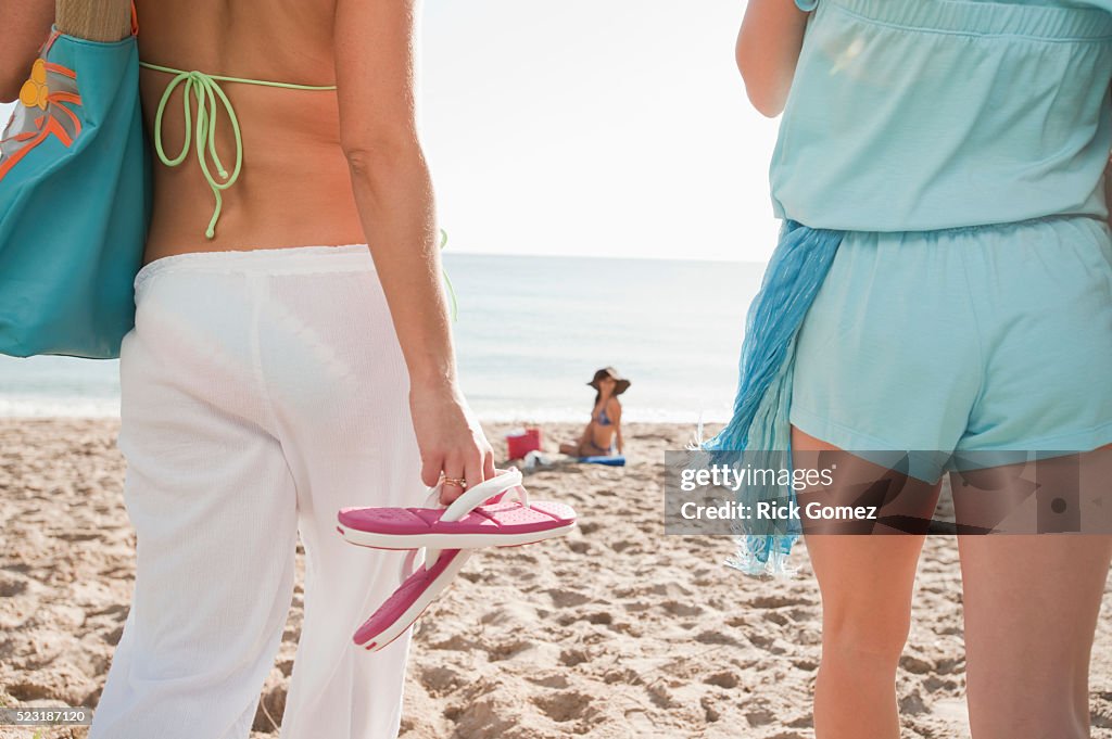 Friends walking on beach