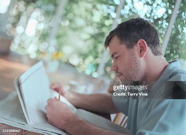 man reading a newspaper - left hand stock pictures, royalty-free photos & images