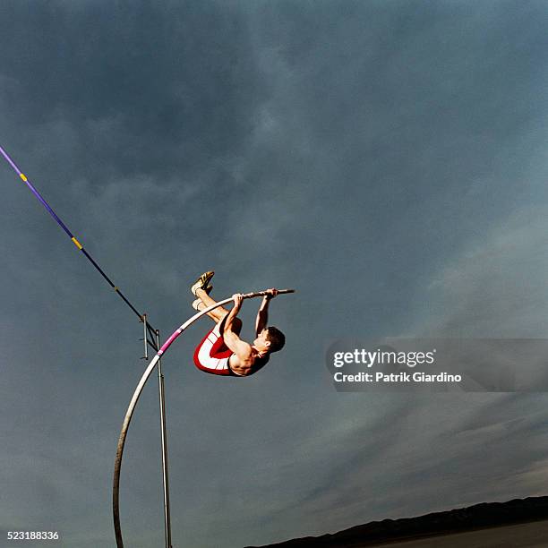 man pole vaulting - pole vaulter stock pictures, royalty-free photos & images