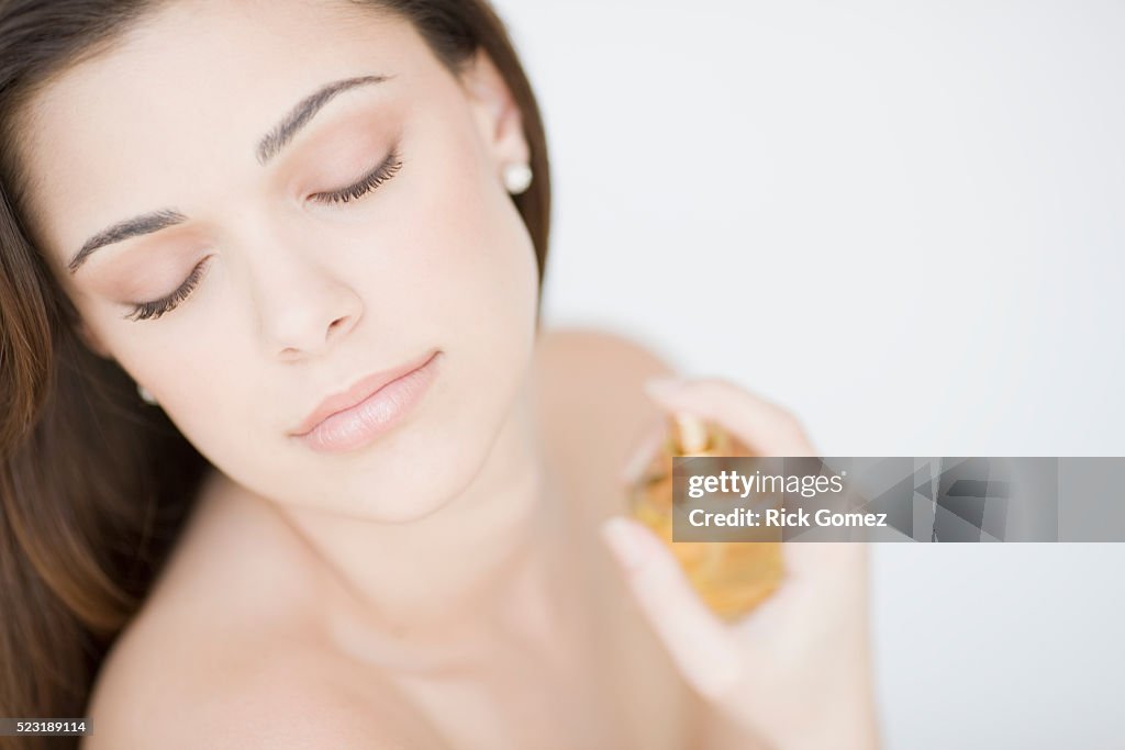 Young Woman Spraying Perfume