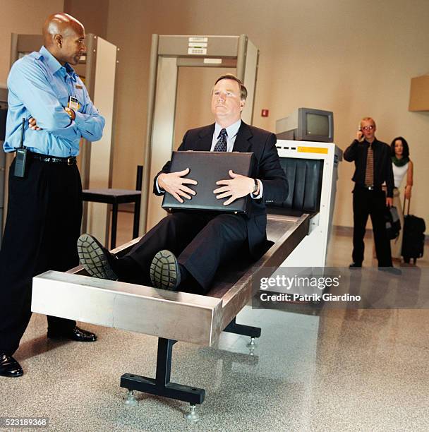 businessman sitting on airport x-ray - metal detector security stock pictures, royalty-free photos & images