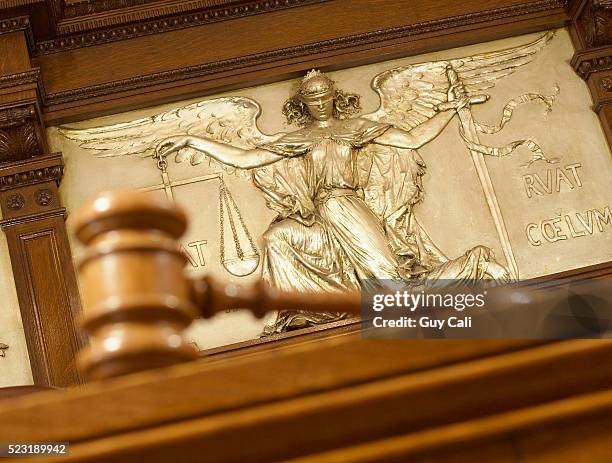 gavel and figure of justice - empty courtroom stock-fotos und bilder