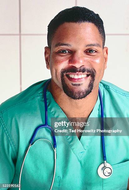 smiling african-american male nurse or doctor in scrubs. - goatee stockfoto's en -beelden