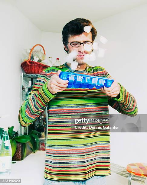 man popping ice cubes from tray - ice cube tray stock pictures, royalty-free photos & images