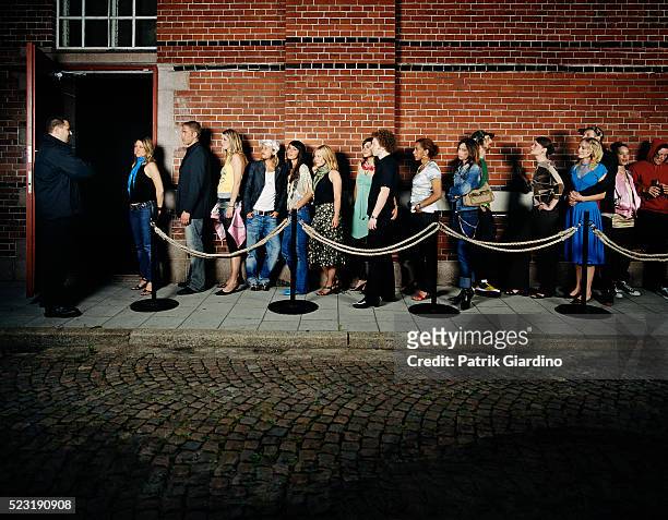 people waiting in line outside club - waiting in line stock-fotos und bilder