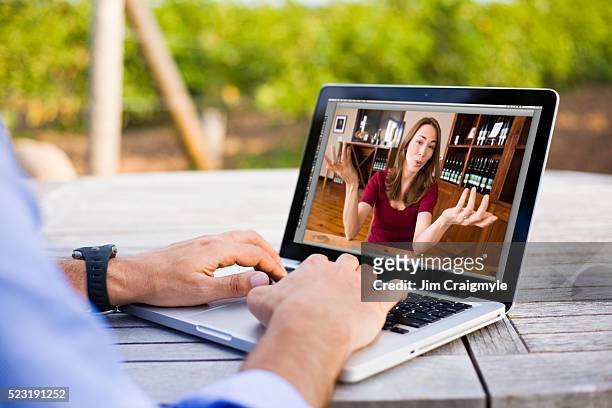 farmer at a picnic table having a video chat with woman - jim farmer stock pictures, royalty-free photos & images