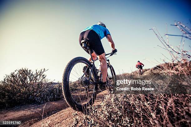 two adult men riding mountain bikes up on a steep trail on a hill in california - robb reece stock pictures, royalty-free photos & images