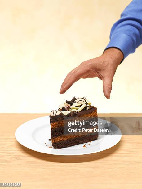 man reaching for cake - cake slices imagens e fotografias de stock