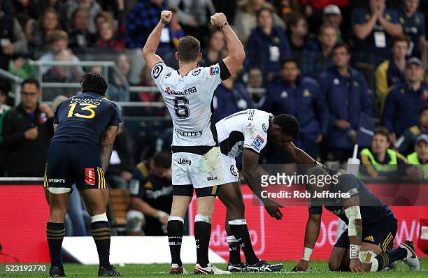 Keegan Daniel of the Sharks celebrates their win over the Highlanders while Lwazi Mvovo of the Sharks puts out a helping hand to a dejected Patrick...