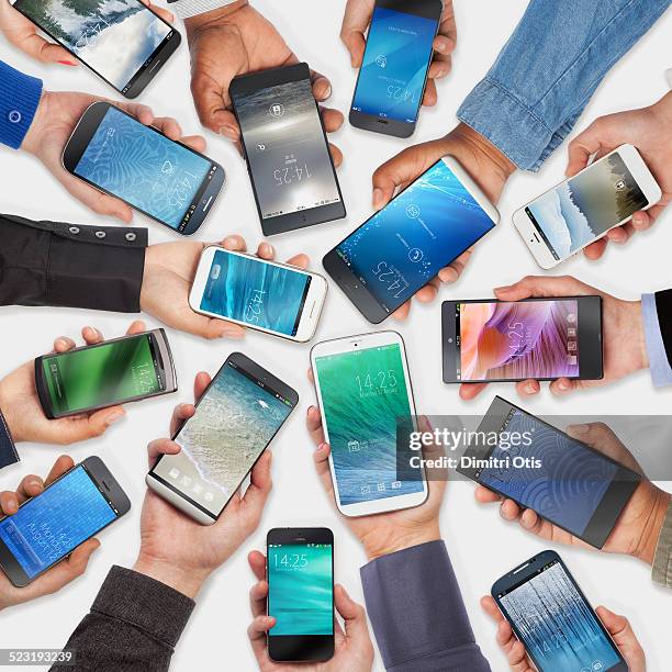 hands holding cell phones, white background - holding aloft stock-fotos und bilder