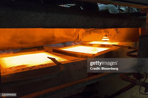 Molten copper sits in casting molds during the production of anode plates at the Aurubis AG metals plant in Hamburg, Germany, on Thursday, April 21,...