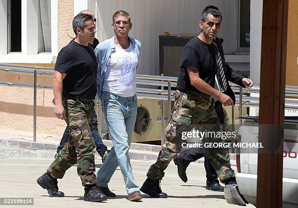 Cypriot security personnel escort Egyptian Seif al-Din Mohamed Mostafa who is accused of hijacking an EgyptAir plane and diverting it to Cyprus on...