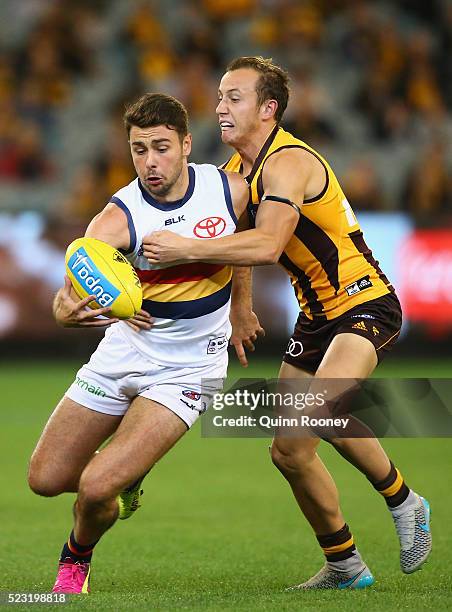 Rory Atkins of the Crows is tackled by Billy Hartung of the Hawks during the round five AFL match between the Hawthorn Hawks and the Adelaide Crows...