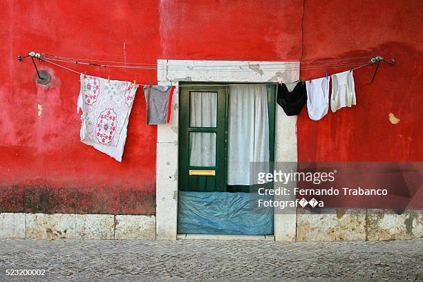 colorful laundry on lines - lavanderia stock-fotos und bilder