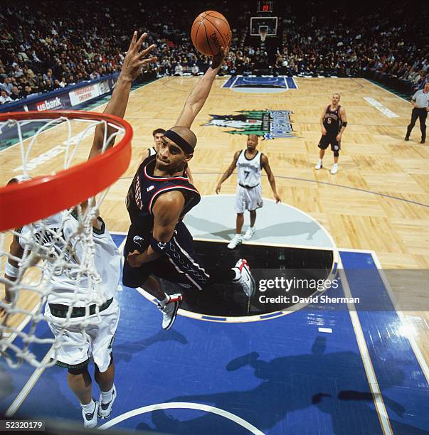 Vince Carter of the New Jersey Nets goes for a dunk against Eddie Griffin of the Minnesota Timberwolves during the game at Target Center on February...