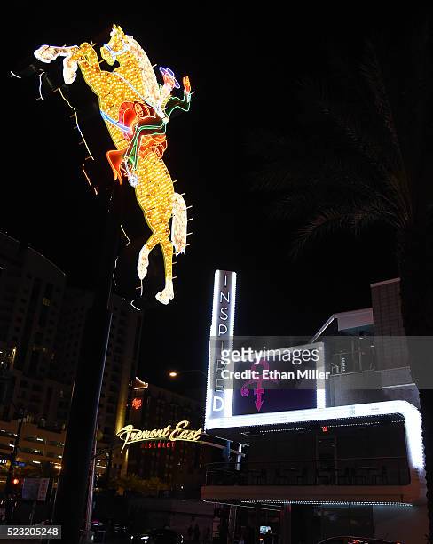 Sign at Inspire Las Vegas displays a tribute to recording artist Prince next to the Hacienda Horse and Rider neon sign early on April 22, 2016 in Las...