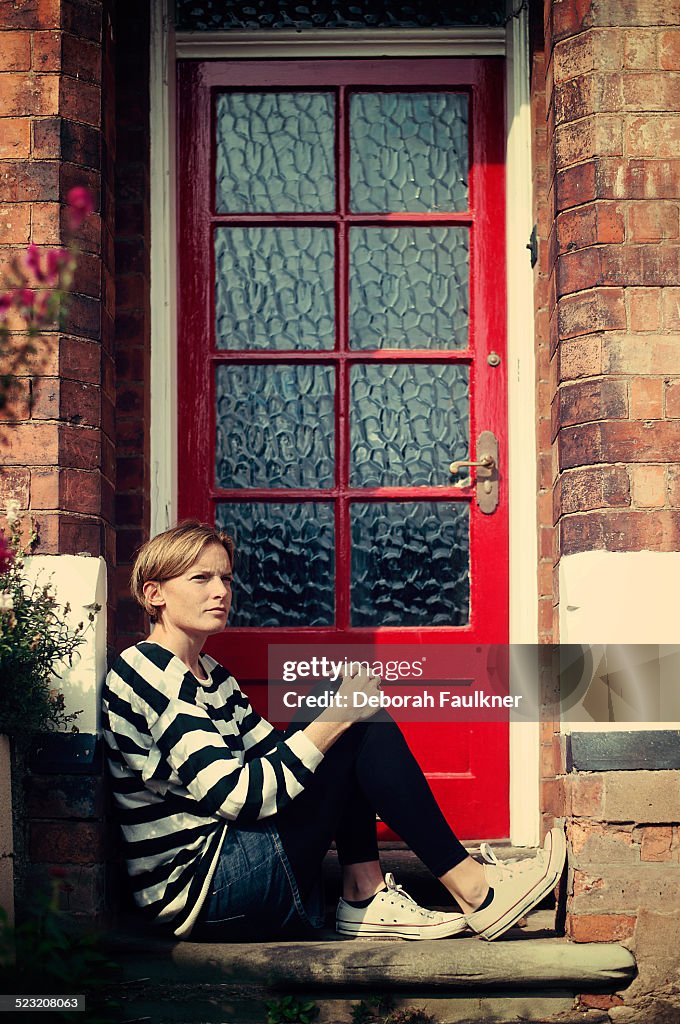 Woman sat on doorstep