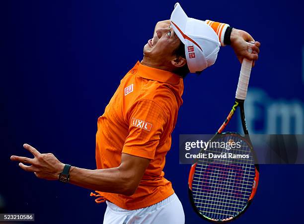 Kei Nishikori of Japan serves against Alexandr Dolgopolov of Ukraine during day five of the Barcelona Open Banc Sabadell at the Real Club de Tenis...