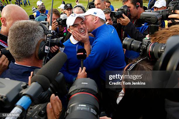 Jamie Donaldson kisses captain Paul McGinley after Donaldson won his match and the cup on the 15th green during the singles on the 3rd day of the...