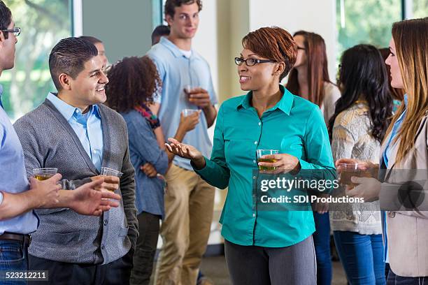 professionals and alumni talking during mixer or party - presentation party stockfoto's en -beelden