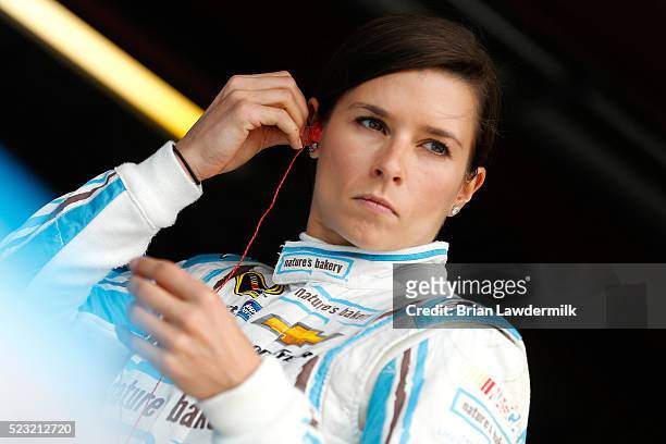 Danica Patrick, driver of the Nature's Bakery Chevrolet, stands in the garage area during practice for the NASCAR Sprint Cup Series TOYOTA OWNERS 400...