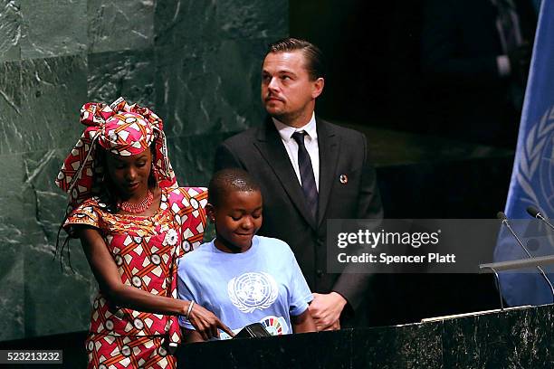 Actor and climate activist Leonardo DiCaprio stands with children at the United Nations Signing Ceremony for the Paris Agreement climate change...