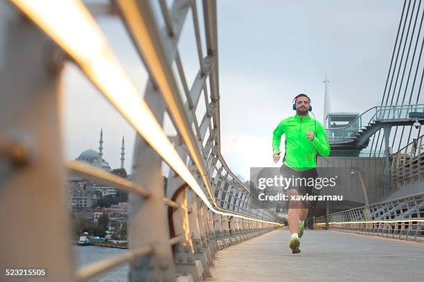 man running in istanbul - istanbul bridge stock pictures, royalty-free photos & images