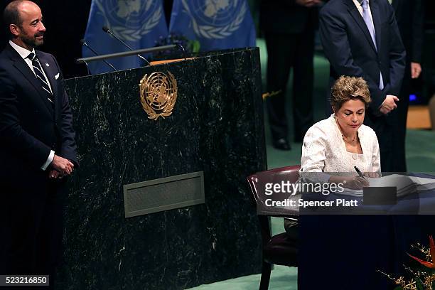 Brazilian President Dilma Rousseff signs the accord at the United Nations Signing Ceremony for the Paris Agreement climate change accord that came...