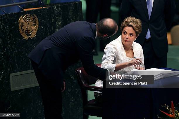 Brazilian President Dilma Rousseff signs the accord at the United Nations Signing Ceremony for the Paris Agreement climate change accord that came...