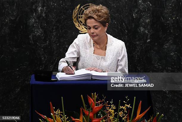 President of Brazil, Dilma Rousseff signs an agreement during the high level signature ceremony for the Paris Agreement on Climate at the United...