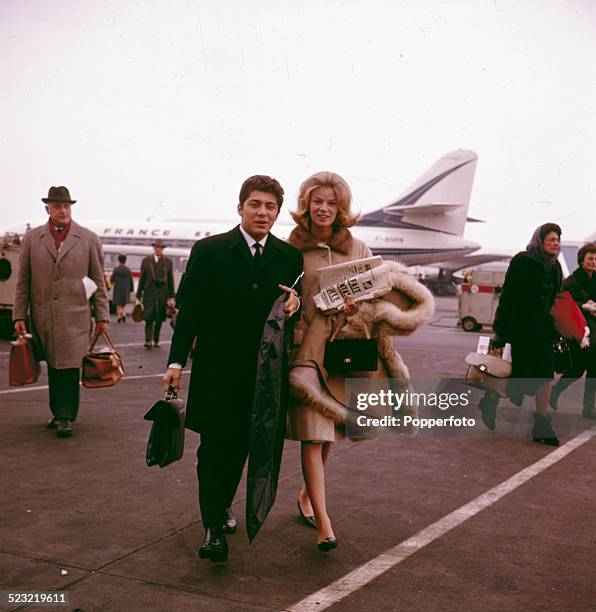Canadian singer Paul Anka pictured with his wife Anne de Zogheb arriving at an airport in Paris in 1963.