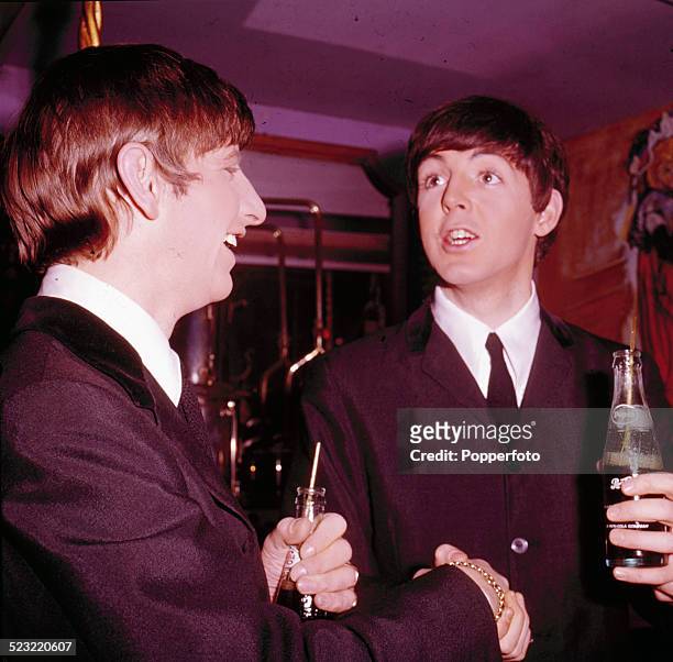 Ringo Starr and Paul McCartney from The Beatles hold bottles of Pepsi Cola in Paris, France in January 1964.