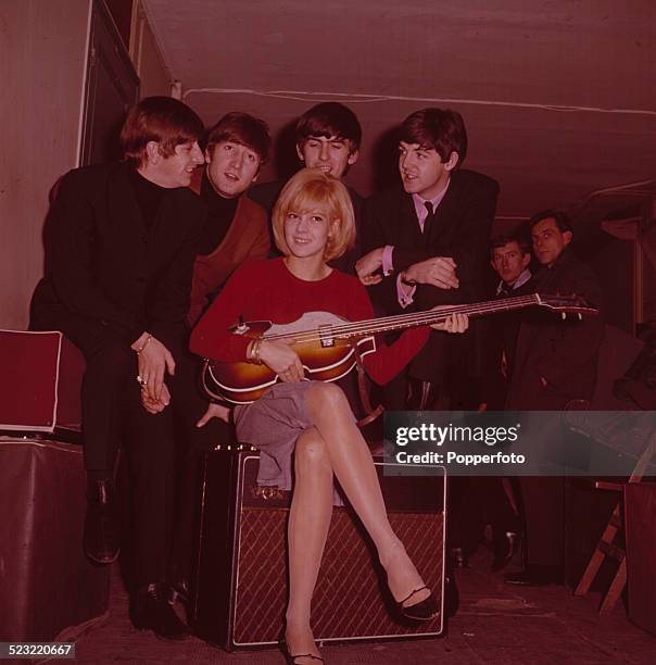 English group The Beatles posed with French singer Sylvie Vartan in Paris in January 1964. From left to right: Ringo Starr, John Lennon , Sylvie...