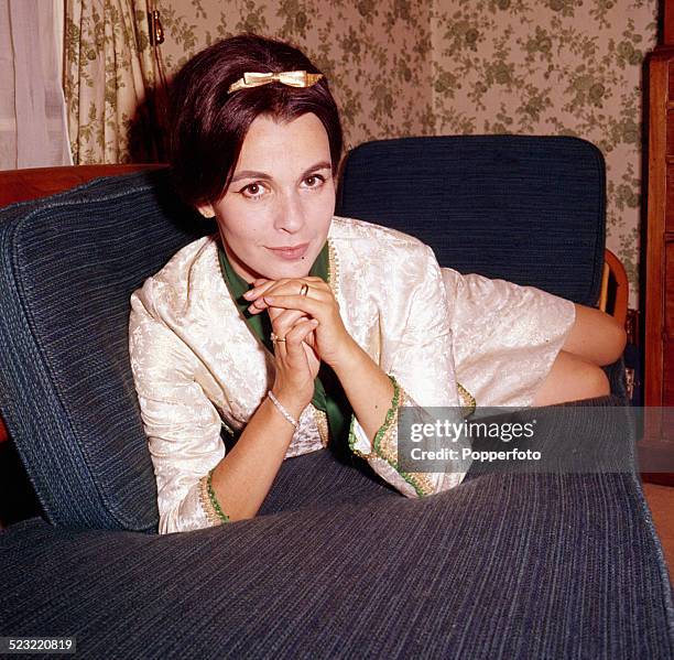 English actress Claire Bloom posed sitting on a sofa in 1964.