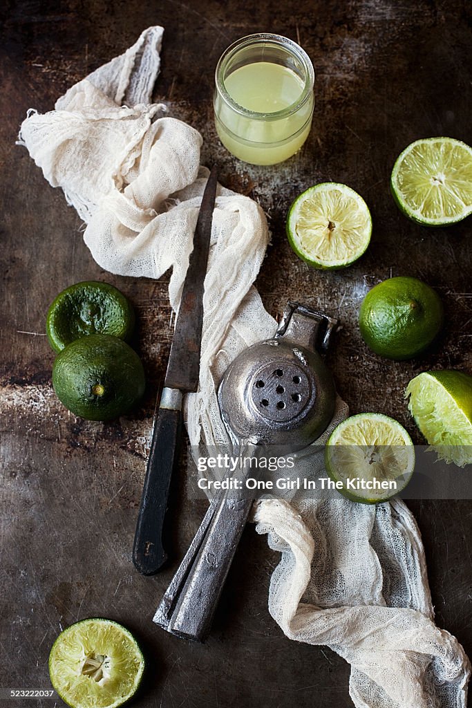 Lime halves and juice with knife and squeezer