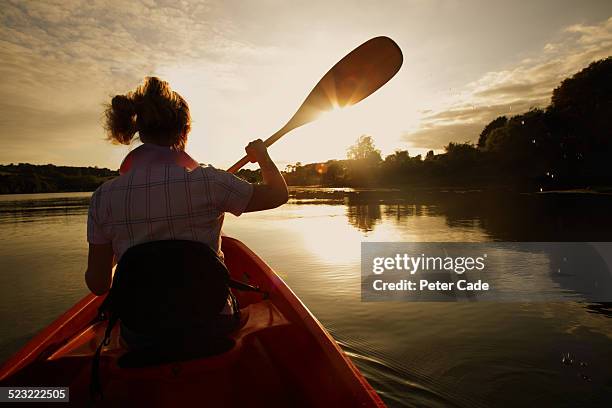 woman in canoe at sunset - woman and river uk stock pictures, royalty-free photos & images