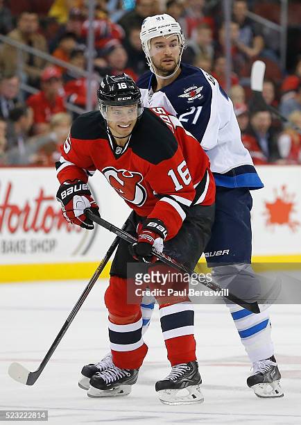 Jacob Josefson of the New Jersey Devils plays in the game against T.J. Galiardi of the Winnipeg Jets at Prudential Center on October 30, 2014 in...
