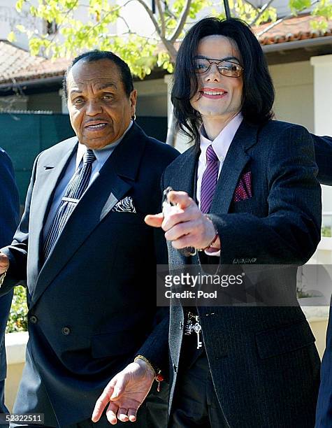 Singer Michael Jackson gestures as he and his father, Joseph Jackson, depart the Santa Maria Superior Court during the second week of Michael's child...