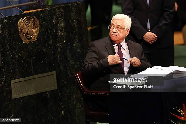 Palestinian Authority President Mahmoud Abbas signs the accord at the United Nations Signing Ceremony for the Paris Agreement climate change accord...