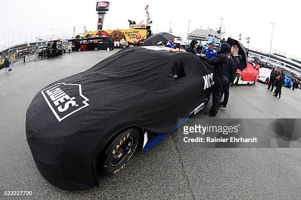 The Lowe's Pro Services Chevrolet, driven by Jimmie Johnson , is seen covered as it rains at Richmond International Raceway on April 22, 2016 in...